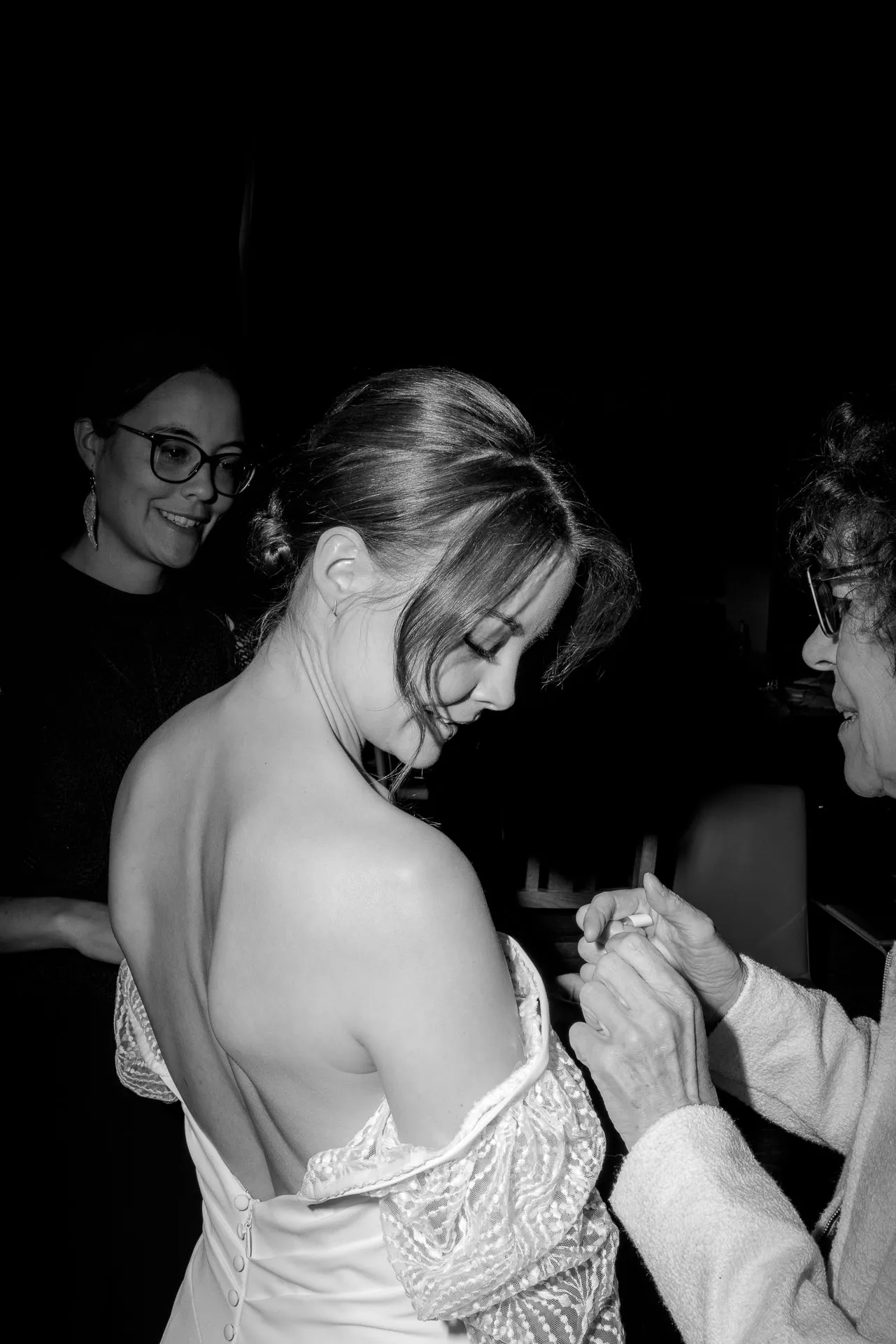 Braut wird beim Anziehen des Brautkleides geholfen auf Gut Sonnenhausen Hochzeit